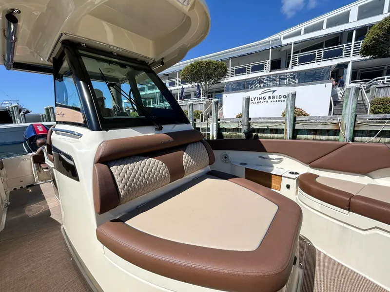 Slide: The Image of 2024 Chris-Craft Catalina boat interior with luxurious seating at a marina. - 7