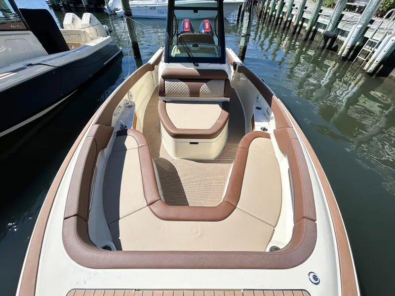 Slide: The Image of 2024 Chris-Craft Catalina boat with luxurious seating, docked at a marina. - 8