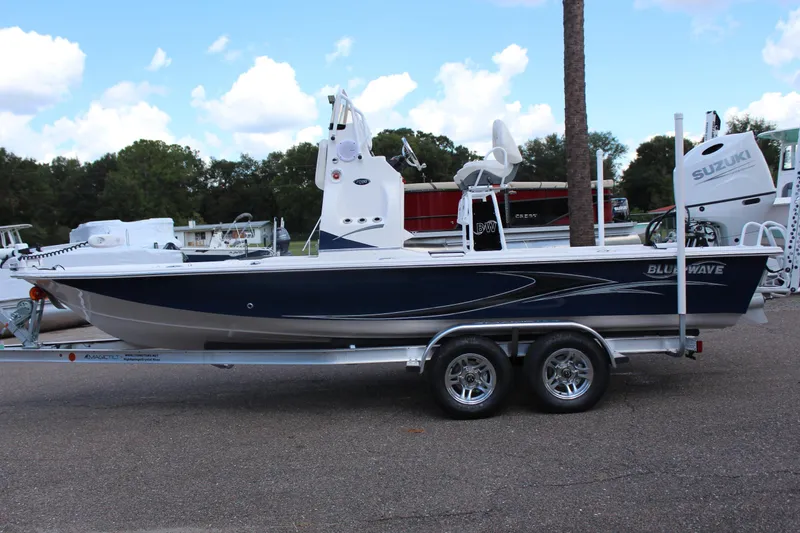 Slide: The Image of 2024 Blue Wave 2200 STL boat on a trailer with Suzuki outboard motor. - 3