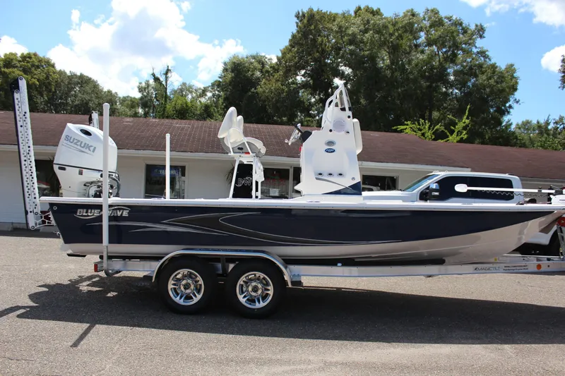 Slide: The Image of 2024 Blue Wave 2200 STL boat on a trailer with Suzuki outboard motor. - 5