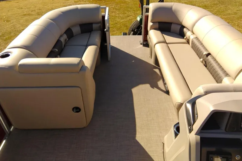 Slide: The Image of 2024 Sun Tracker Party Barge 20 DLX interior with beige seating and spacious layout. - 4