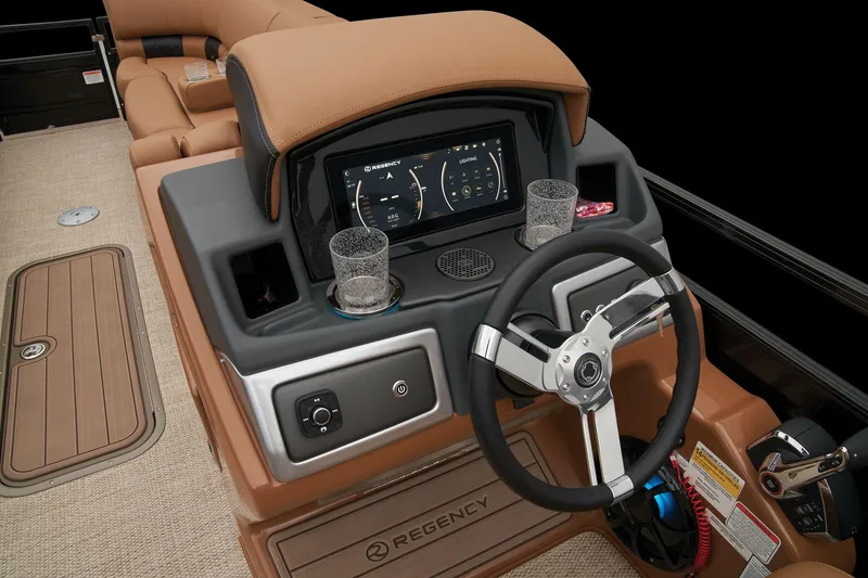Slide: The Image of 2024 Regency 250 LE3 boat dashboard with steering wheel, touchscreen display, and cup holders. - 40