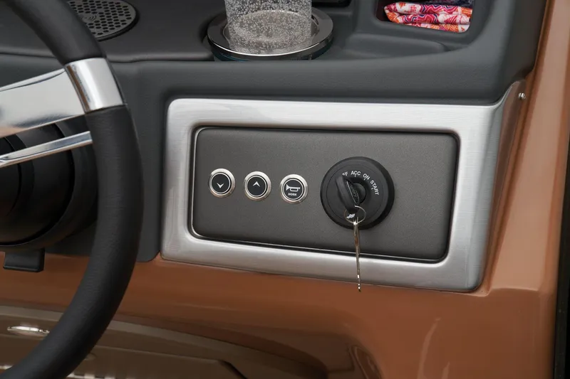 Slide: The Image of Close-up of the 2024 Regency 250 LE3 boat ignition panel and controls. - 44