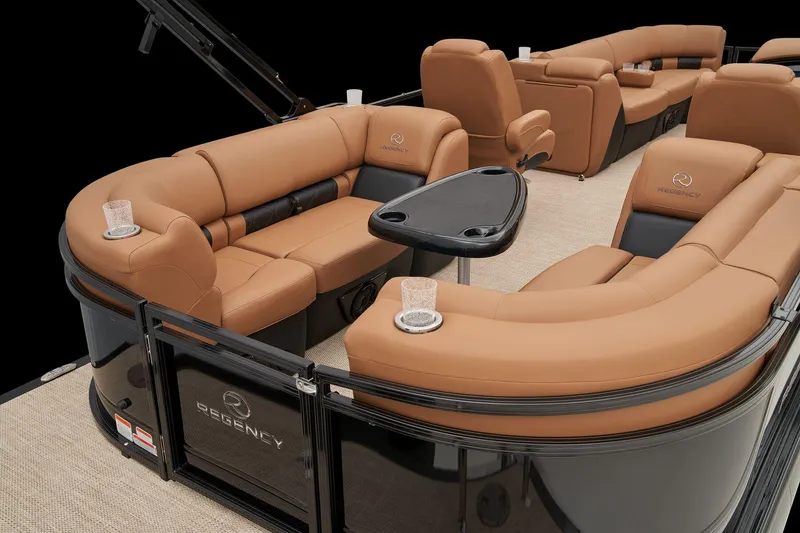 Slide: The Image of 2024 Regency 250 LE3 pontoon boat with luxurious tan seating and cup holders. - 49