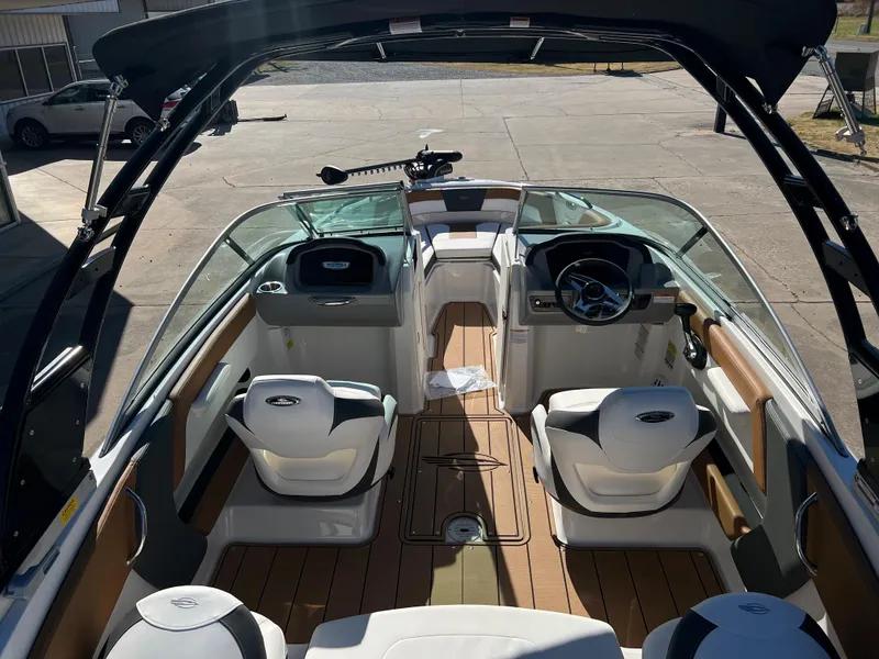 Slide: The Image of 2024 Chaparral 21 SSI SF boat interior with seating and steering wheel. - 4