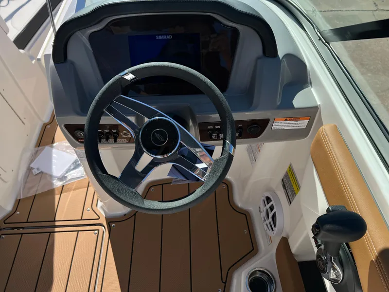 Slide: The Image of 2024 Chaparral 21 SSI SF boat dashboard with steering wheel and control panel. - 5