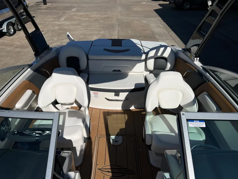 Slide: The Image of 2024 Chaparral 21 SSI SF boat interior with white seating and brown flooring. - 6