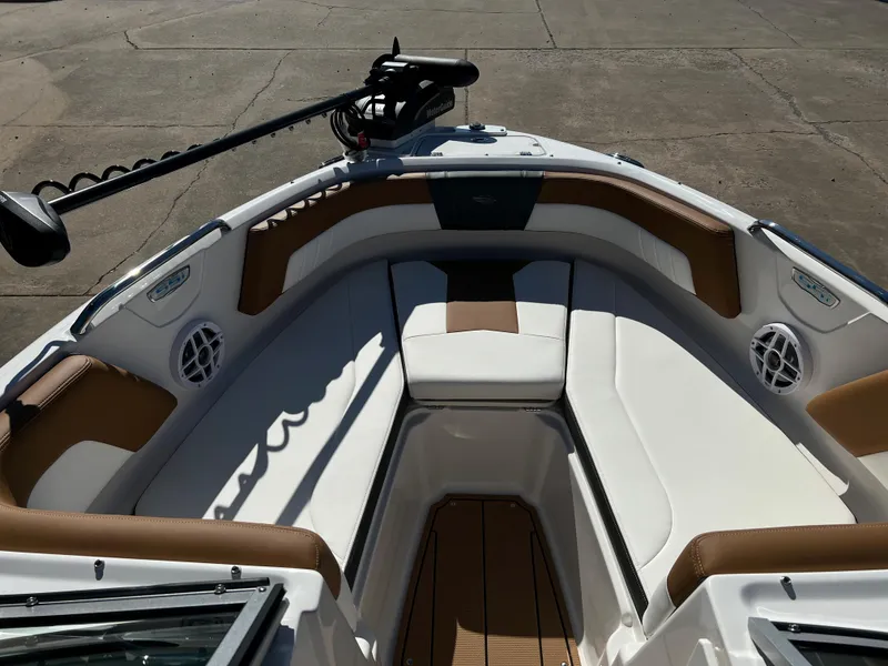 Slide: The Image of 2024 Chaparral 21 SSI SF boat interior with cushioned seating and mounted equipment. - 7