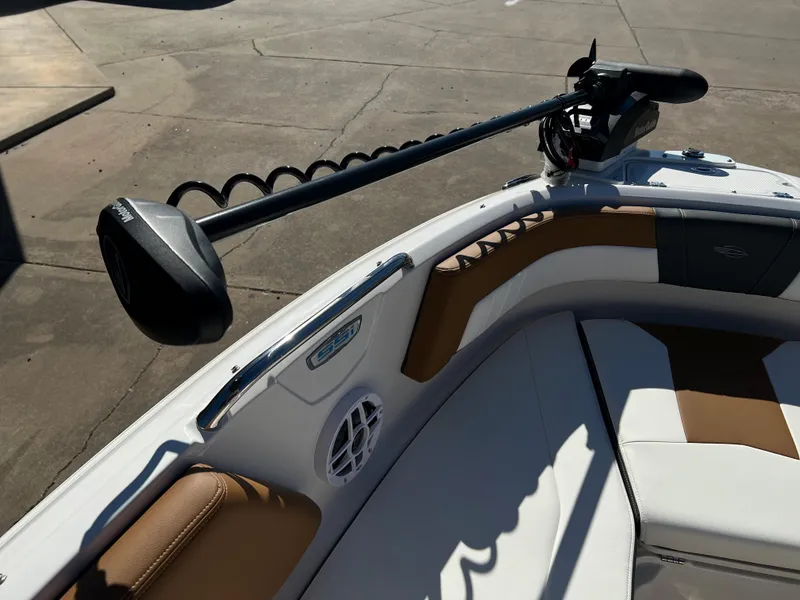 Slide: The Image of 2024 Chaparral 21 SSI SF boat interior with trolling motor and cushioned seating. - 8