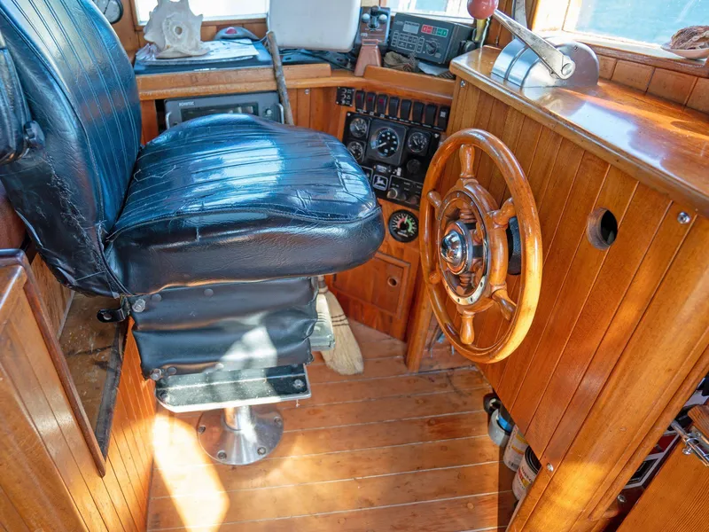 Slide: The Image of Wooden boat helm with leather seat, steering wheel, and control panel, Custom Prothero & Franken, 1997. - 11
