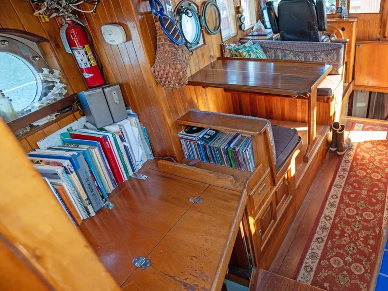 Slide: The Image of Cozy wooden boat interior with books, CDs, and a fire extinguisher, Custom Prothero & Franken, 1997. - 4