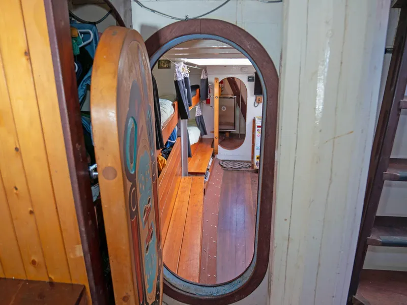 Slide: The Image of Cozy wooden interior of a 1997 Custom Prothero & Franken boat, featuring a mirror and bunks. - 7