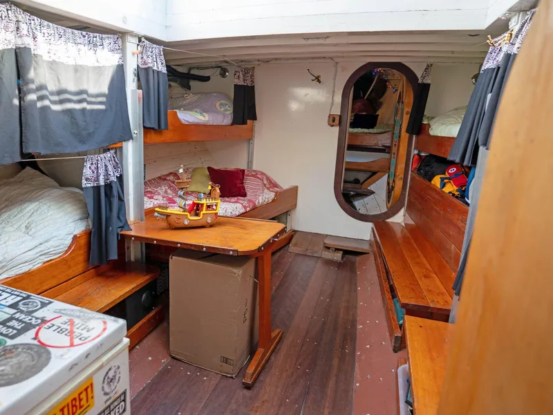 Slide: The Image of Cozy 1997 Prothero & Franken boat interior with wooden furnishings and bunk beds. - 8