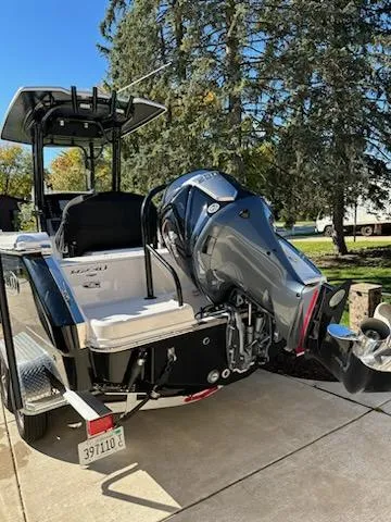 Slide: The Image of 2021 Robalo R230 Center Console boat with outboard motor on trailer. - 2