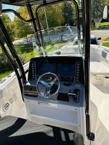Slide: The Image of 2021 Robalo R230 Center Console boat dashboard with steering wheel and navigation screens. - 4