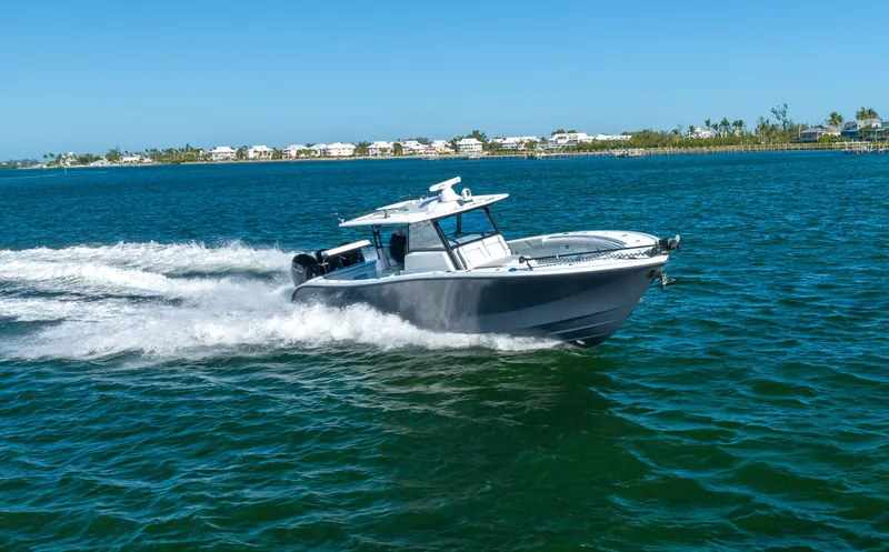 Slide: The Image of 2023 Yellowfin 42 boat cruising on a sunny day in coastal waters. - 22