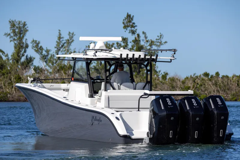 Slide: The Image of 2023 Yellowfin 42 boat with triple outboard engines on the water. - 24