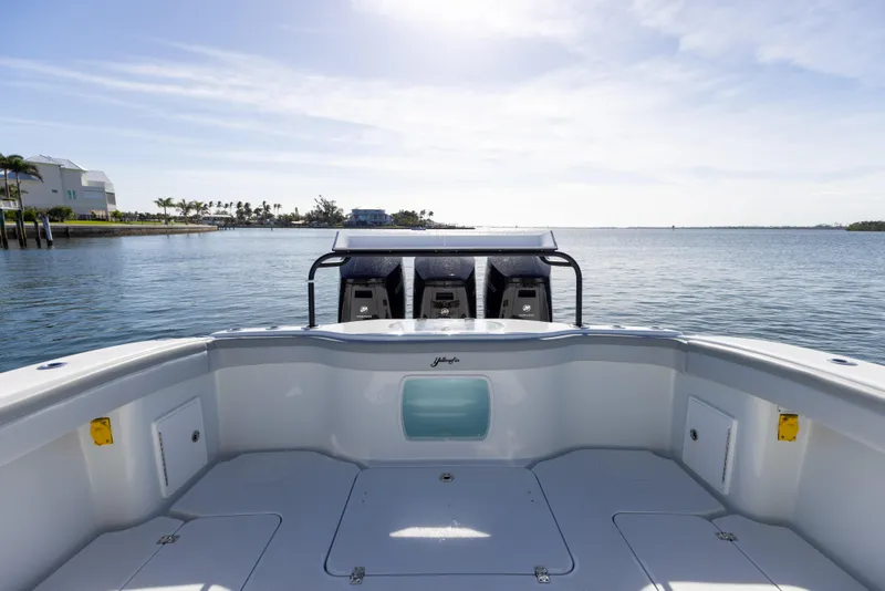 Slide: The Image of 2023 Yellowfin 42 boat with triple outboard engines on calm water. - 25