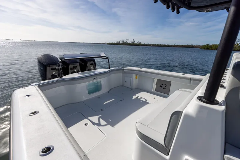 Slide: The Image of 2023 Yellowfin 42 boat, spacious deck, twin outboard motors, calm waters. - 26