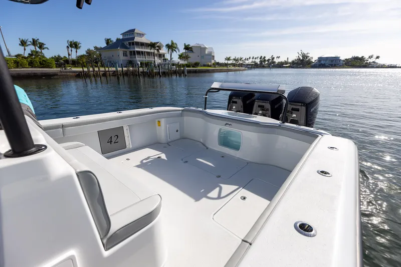 Slide: The Image of 2023 Yellowfin 42 boat docked near waterfront homes. - 29