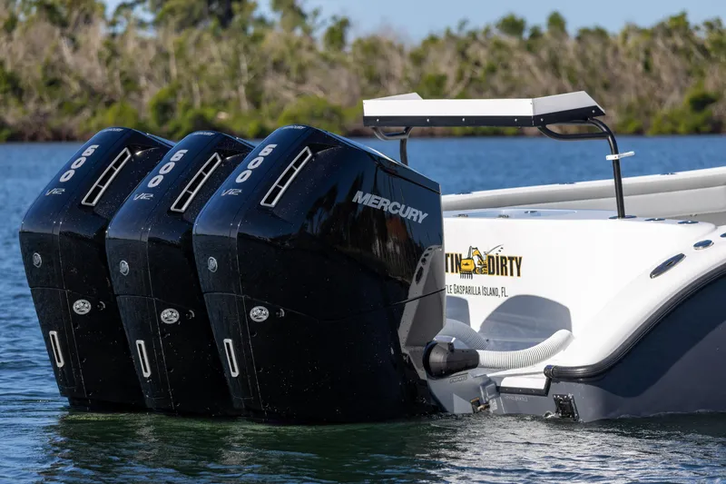 Slide: The Image of 2023 Yellowfin 42 boat with triple Mercury outboard engines on water. - 3