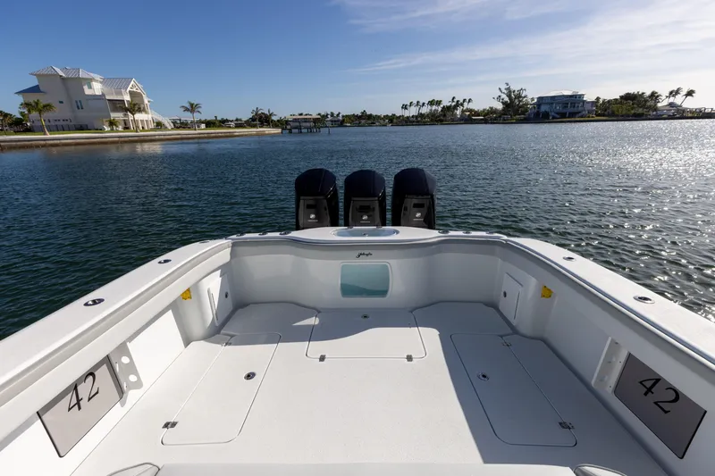 Slide: The Image of 2023 Yellowfin 42 boat with triple outboard engines on calm water. - 30