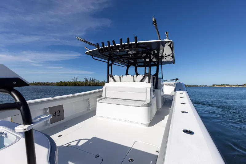 Slide: The Image of 2023 Yellowfin 42 boat on calm water, clear blue sky. - 33