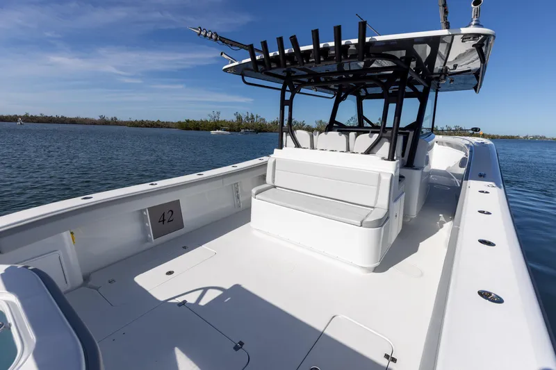 Slide: The Image of 2023 Yellowfin 42 boat with spacious deck and seating, cruising on calm waters. - 34