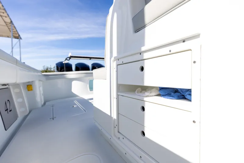 Slide: The Image of 2023 Yellowfin 42 boat interior with storage compartments and outboard motors. - 37