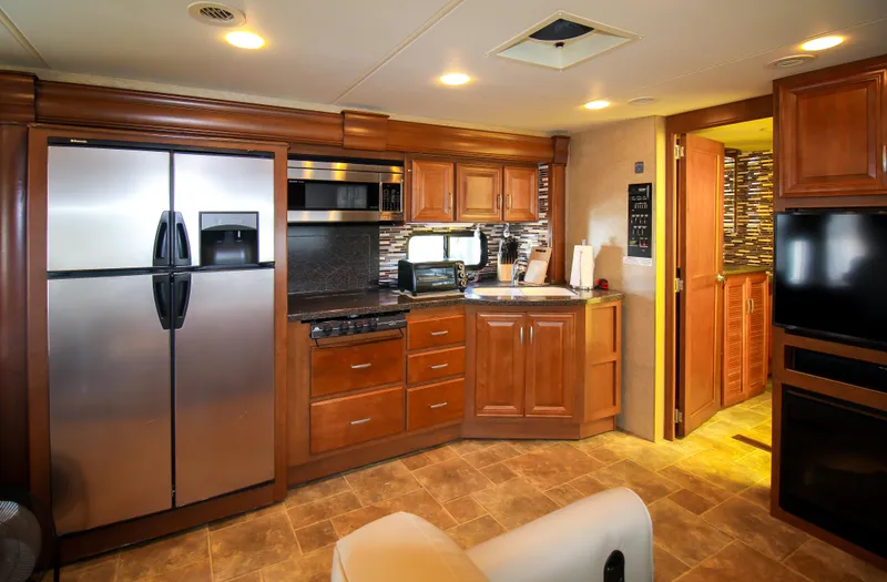 Slide: The Image of Modern kitchen interior in 2012 Thor 37DT RV with stainless steel appliances. - 10