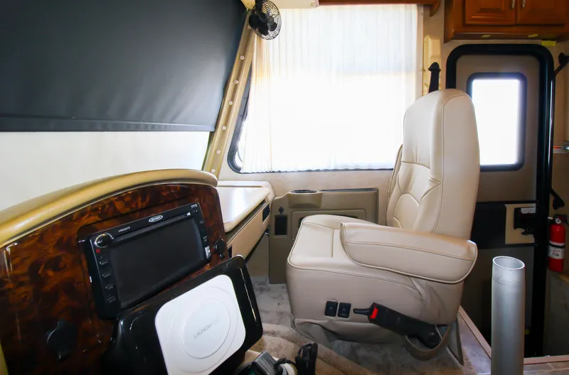 Slide: The Image of 2012 Thor 37DT RV driver's seat and dashboard interior. - 15