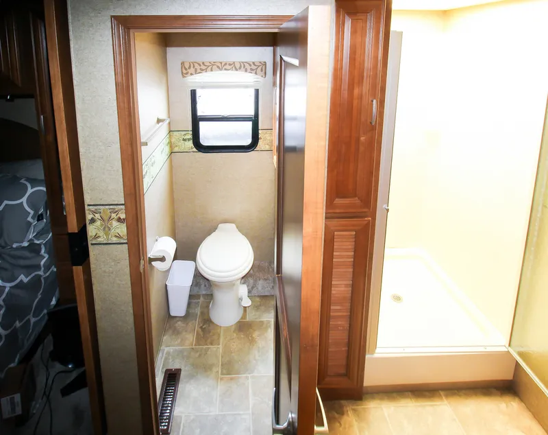 Slide: The Image of 2012 Thor 37DT RV bathroom with toilet, shower, and window. - 20