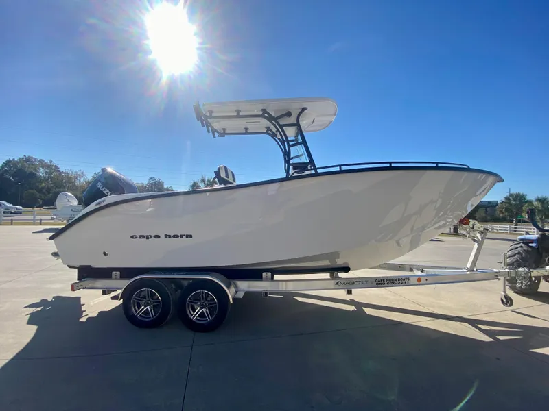 Slide: The Image of 2024 Cape Horn 22OS boat on a trailer under a bright sun. - 1