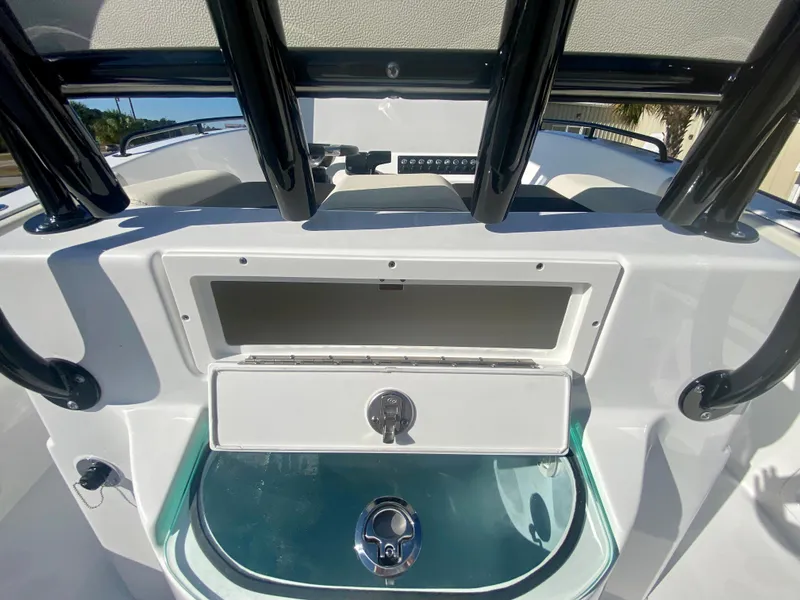 Slide: The Image of 2024 Cape Horn 22OS boat console with storage compartments and livewell. - 12