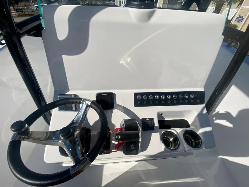 Slide: The Image of 2024 Cape Horn 22OS boat console with steering wheel and controls. - 17