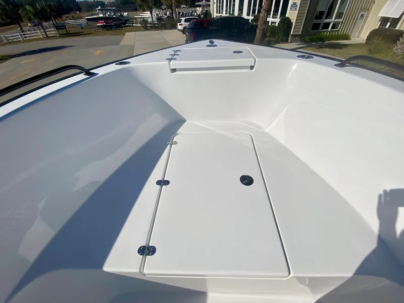 Slide: The Image of 2024 Cape Horn 22OS boat interior, spacious deck with storage compartments. - 26