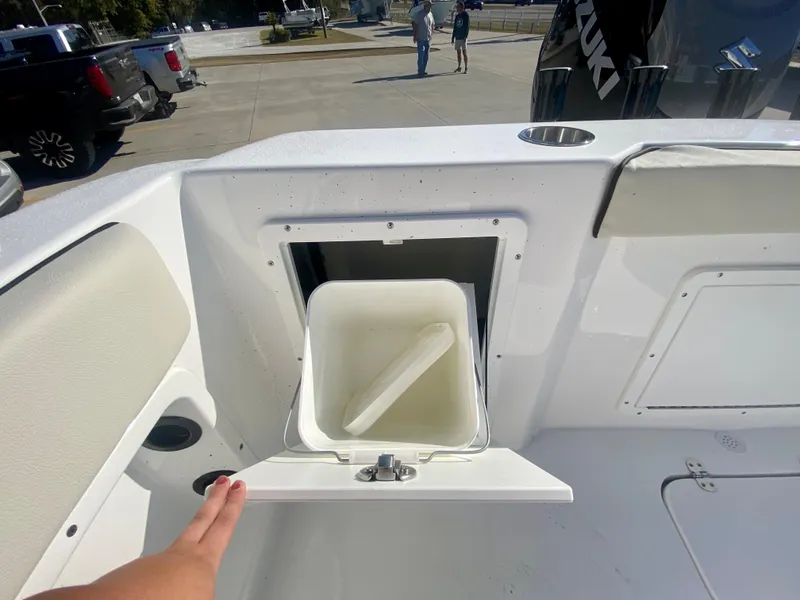 Slide: The Image of 2024 Cape Horn 22OS boat with open storage compartment and white bucket. - 7