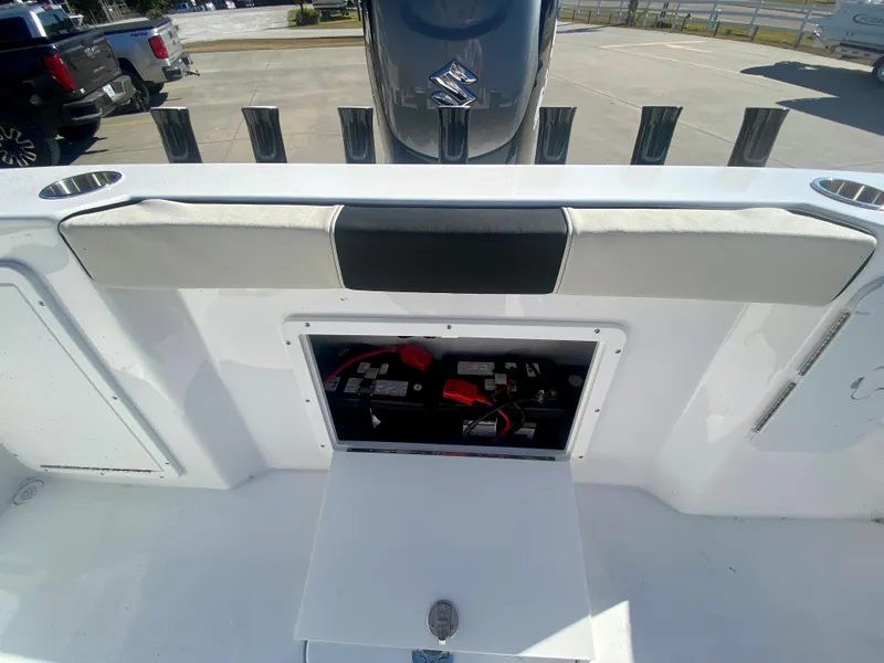 Slide: The Image of 2024 Cape Horn 22OS boat with open storage compartment and Suzuki outboard motor. - 8