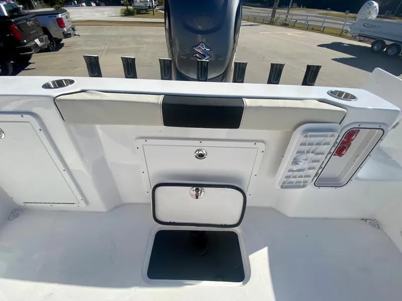 Slide: The Image of 2024 Cape Horn 22OS boat stern with storage compartments and Suzuki outboard motor. - 9
