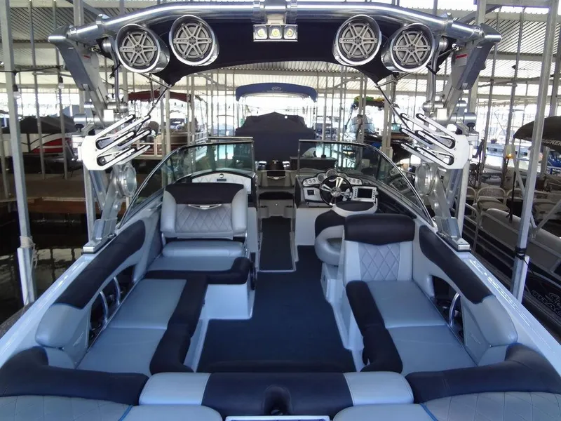 Slide: The Image of 2013 MasterCraft X55 boat interior with diamond-stitched upholstery and black accents. - 12