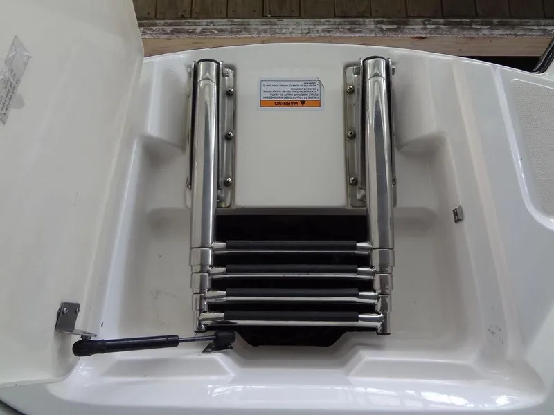 Slide: The Image of 2013 MasterCraft X55 boat storage compartment with latch. - 16