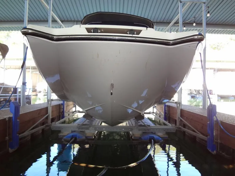 Slide: The Image of 2013 MasterCraft X55 boat on trailer, rear view, parked on a dirt road. - 3