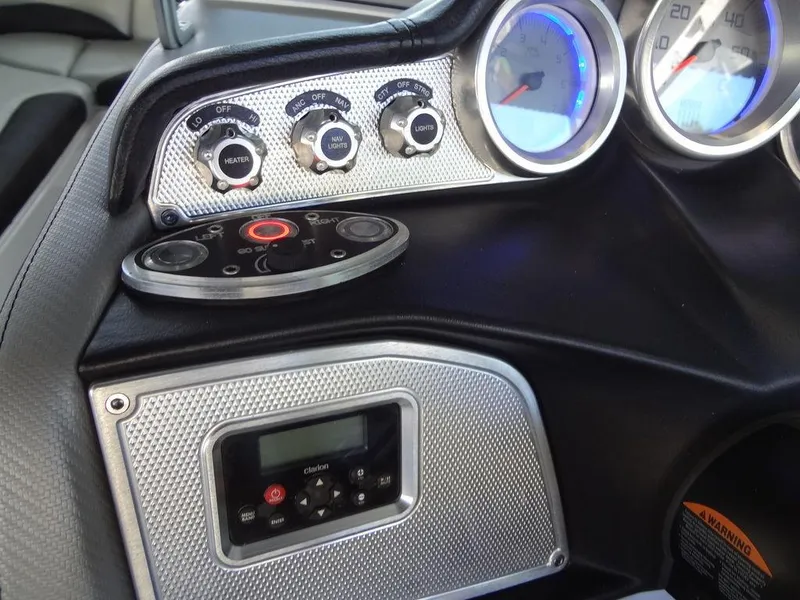 Slide: The Image of 2013 MasterCraft X55 boat dashboard with steering wheel and control panel. - 31