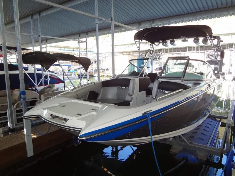 Slide: The Image of 2013 MasterCraft X55 boat docked in a covered marina. - 4