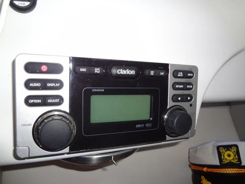 Slide: The Image of 2013 MasterCraft X55 boat interior bathroom with toilet, sink, and captain's hats. - 45