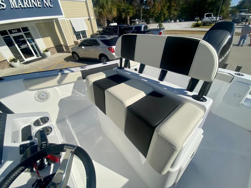 Slide: The Image of 2024 Cape Horn 22OS boat interior with black and white seating at dealership. - 19