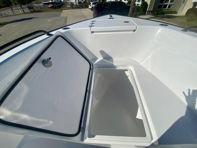 Slide: The Image of 2024 Cape Horn 22OS boat storage compartment with open hatch. - 22
