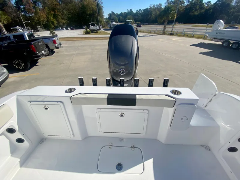 Slide: The Image of 2024 Cape Horn 22OS boat stern with outboard motor and storage compartments. - 6