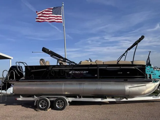 Slide: The Image of 2023 Starcraft CX23FD pontoon boat interior layout with seating and helm. - 1