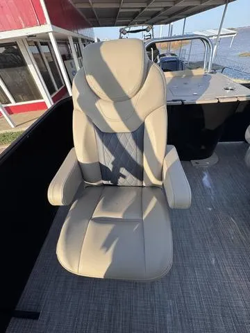 Slide: The Image of 2023 Starcraft CX23FD boat seat with beige upholstery on deck. - 11